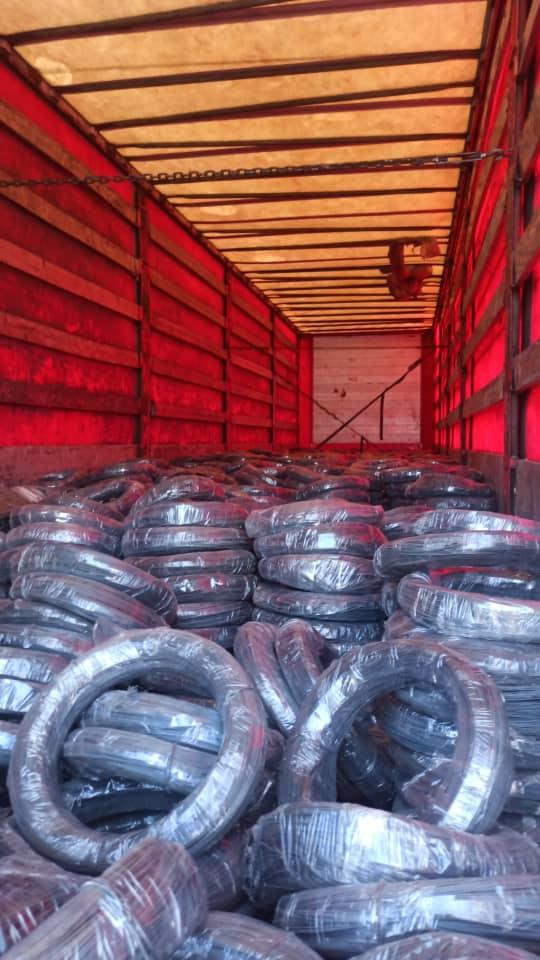 Stacked coils of steel wire rod inside a truck trailer